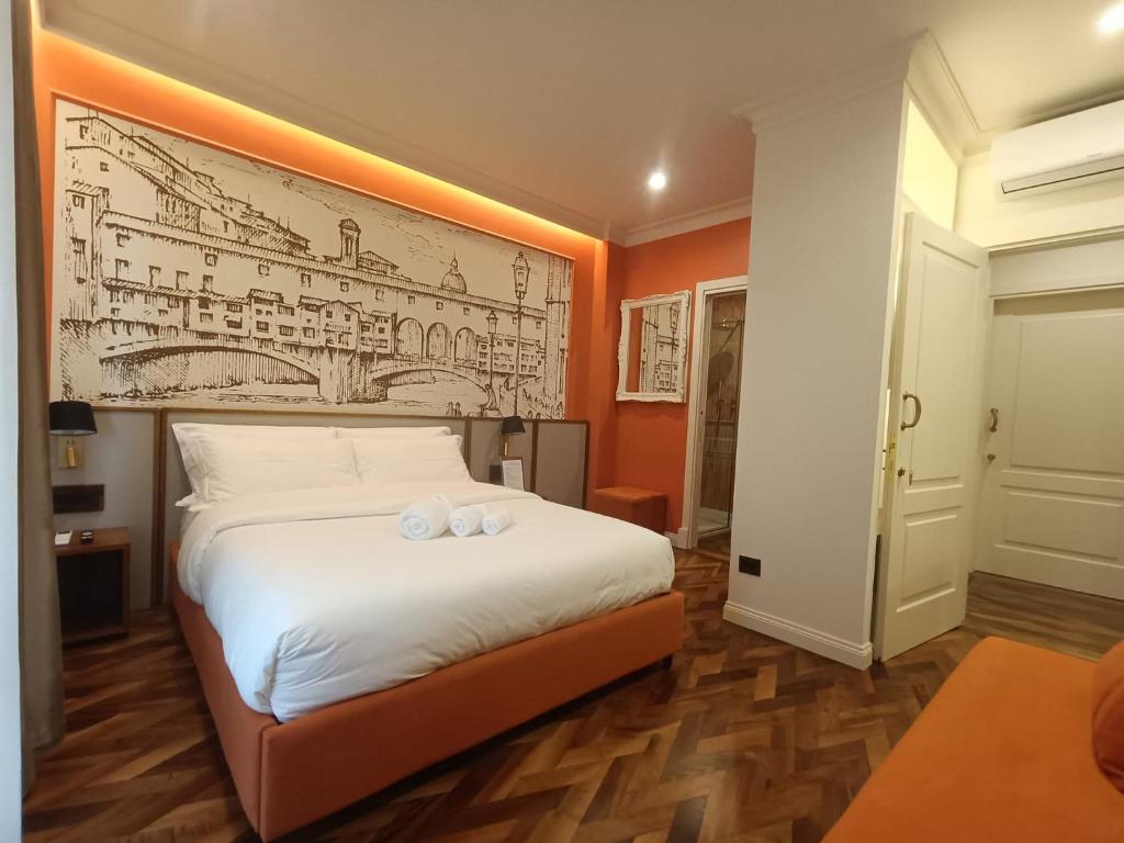 a bedroom with a bed with a drawing on the wall at Aria Domus in Lastra a Signa