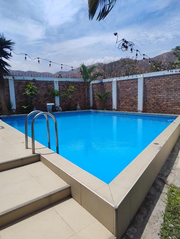 a large swimming pool with blue water at El Sol de Simbal in Trujillo