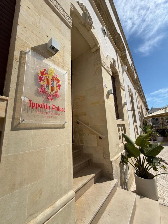 a sign on the side of a building at Ippolita Palace LUXURY ROOMS in Otranto