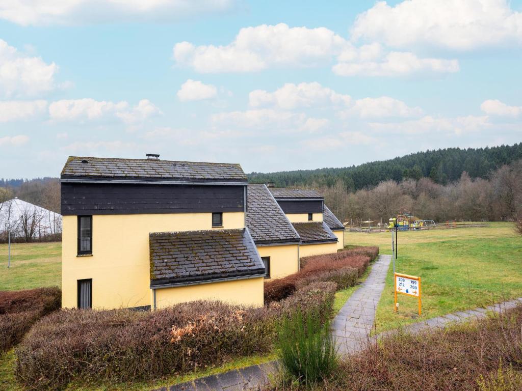 a row of houses in a field with a sign at Hambachtal nature hideaway boutique resort in Oberhambach