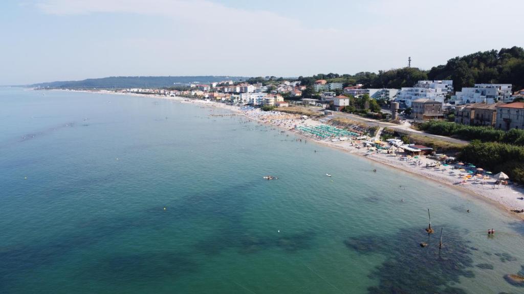 an aerial view of a beach with people in the water at Alta Marea in Fossacesia