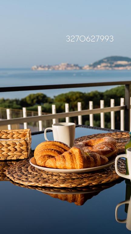 a plate of bread and a cup of coffee on a table at La Vista Formia B&B in Formia