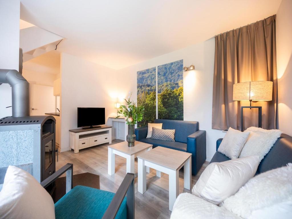 a living room with a couch and a table at Hambachtal forest hideaway boutique resort in Oberhambach
