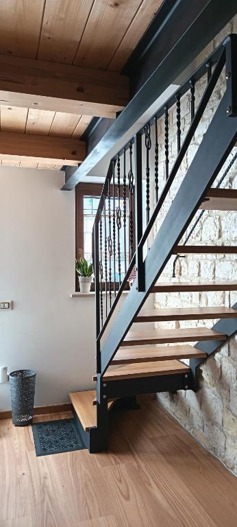 a staircase in a room with a stone wall at casa del corso 27 in Sirolo