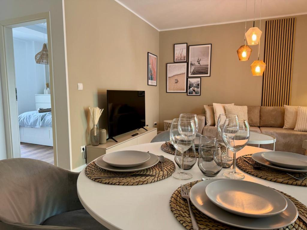 a living room with a table with wine glasses at Glacis Apartments I - Sonnenterasse & kostenlose Parkplätze in Minden