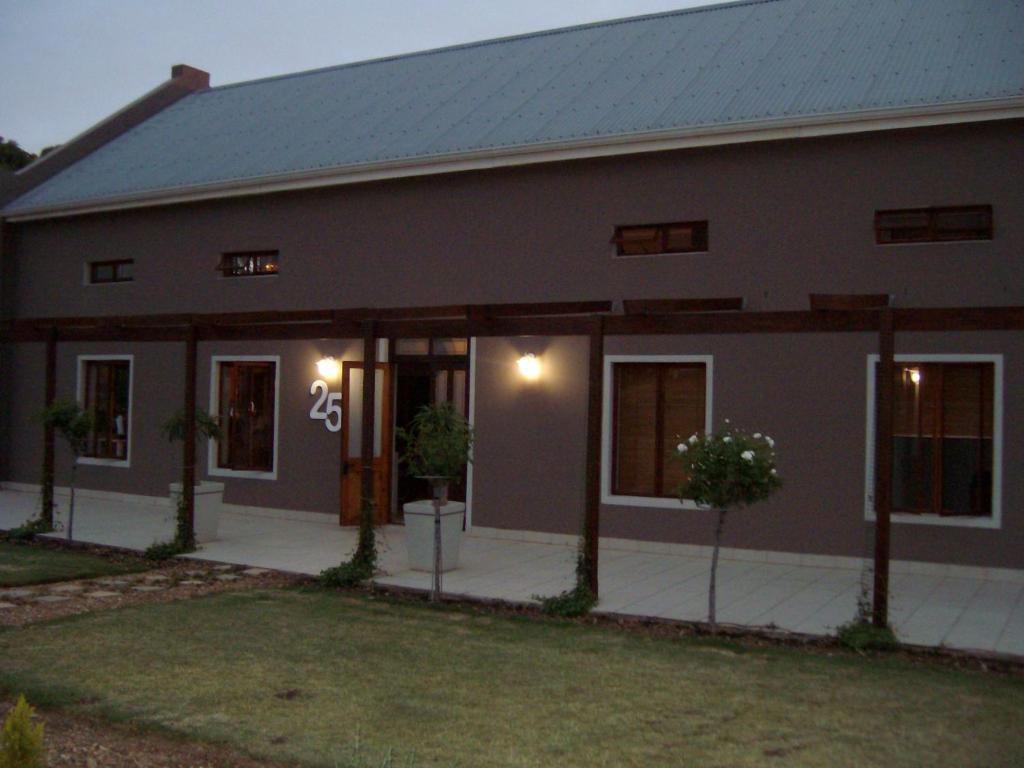 a home with a house with the number on it at The Upper Deck Apartment in Swellendam