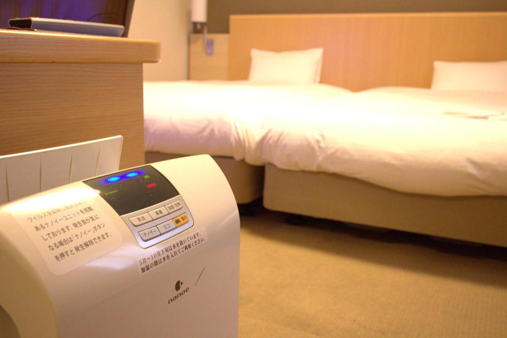 Postel nebo postele na pokoji v ubytování Daiwa Roynet Hotel Hiroshima