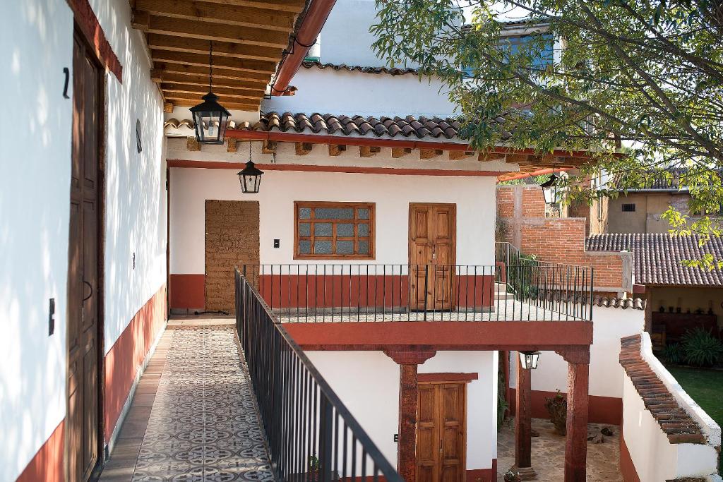 a walkway leading to a house with a porch at La Casita de la Basílica in Pátzcuaro