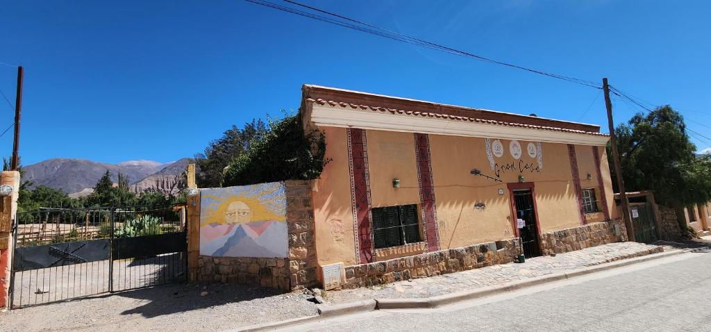 an old building on the side of a street at Gran Casa Hostel&Camping in Tilcara
