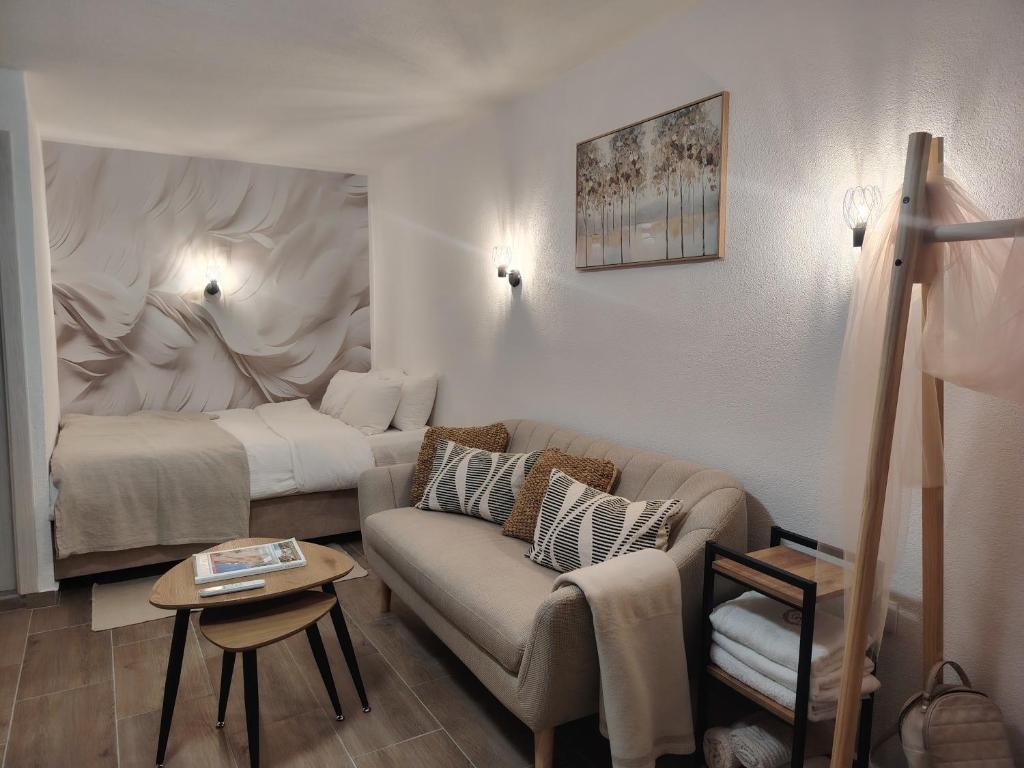 a living room with a couch and a bed at Studio BIANCA in Kotor
