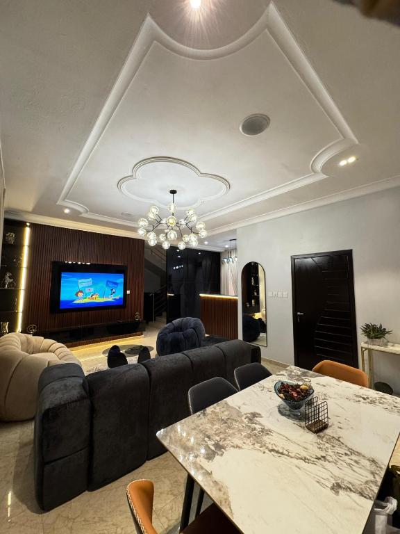 a living room with a couch and a table at Klue Homes in Maiyegun