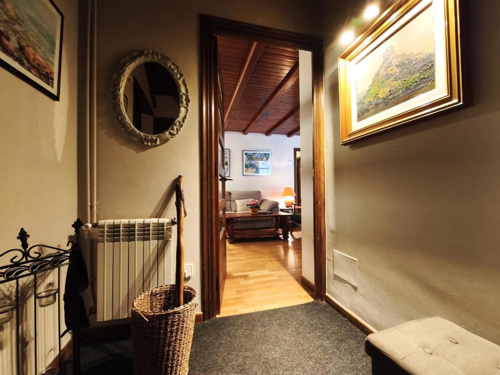 a hallway leading to a living room with a mirror at AC Apartaments Incles in Incles