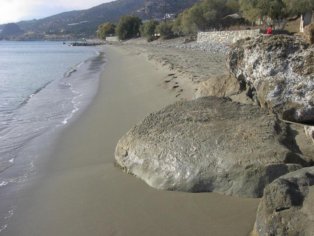 a sandy beach with footprints in the sand at Xenos Apartments in Keratokampos