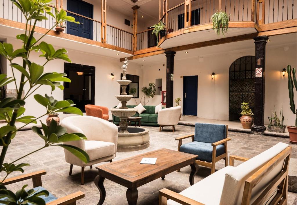a living room with furniture and a fountain at Hotel Ferre Cusco in Cusco