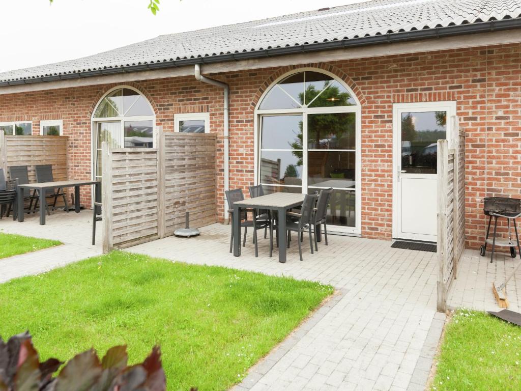 a patio with a table and chairs and a building at Apartment in Groede near the Beach in Groede