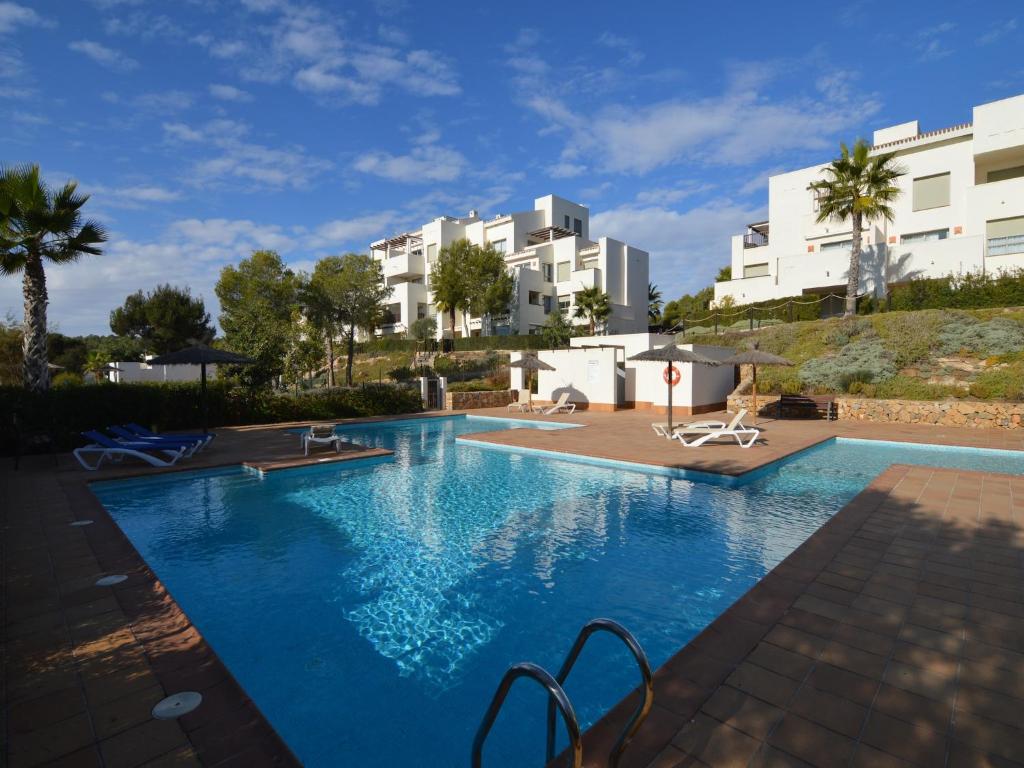 a large swimming pool with buildings in the background at Golfside Luxury at Las Colinas in Orihuela Costa