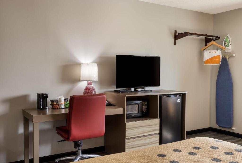 a room with a desk with a computer and a red chair at Econo Lodge Inn & Suites Canandaigua - Finger Lakes Area in Canandaigua
