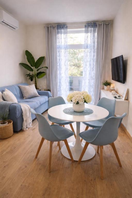 a living room with a table and chairs at ClaMar Apart Hotel in Porto Ercole
