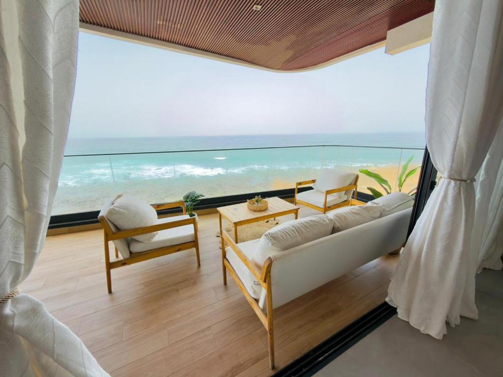 a living room with a couch and a view of the ocean at lunera Immo in Dakan