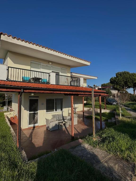 a house with a deck and a patio at Paradise Coast House in Orfánion