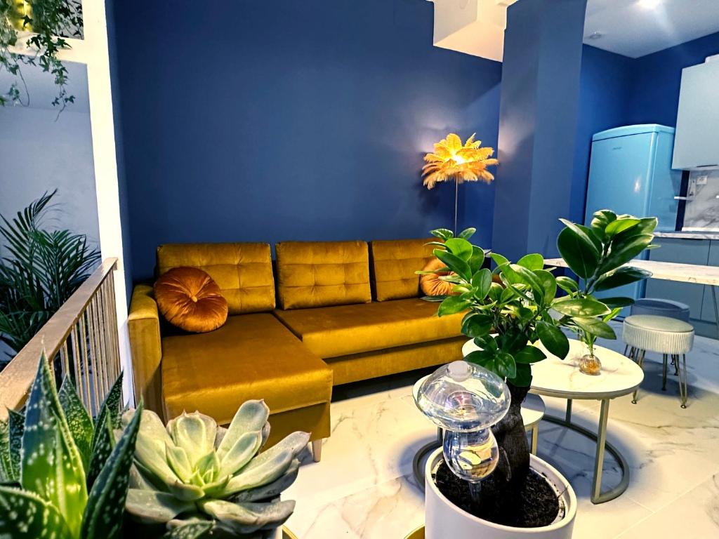 a living room with a couch and lots of plants at Chinatown Luxury Apartment in Madrid