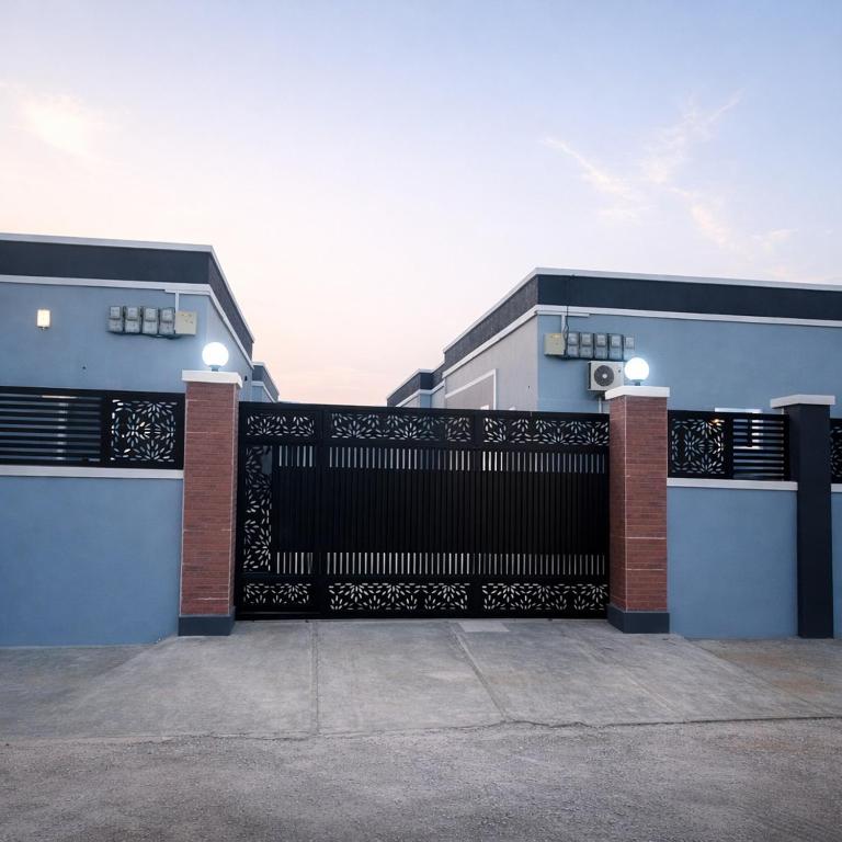 a black gate on the side of a building at Adesta Suites in Ilorin