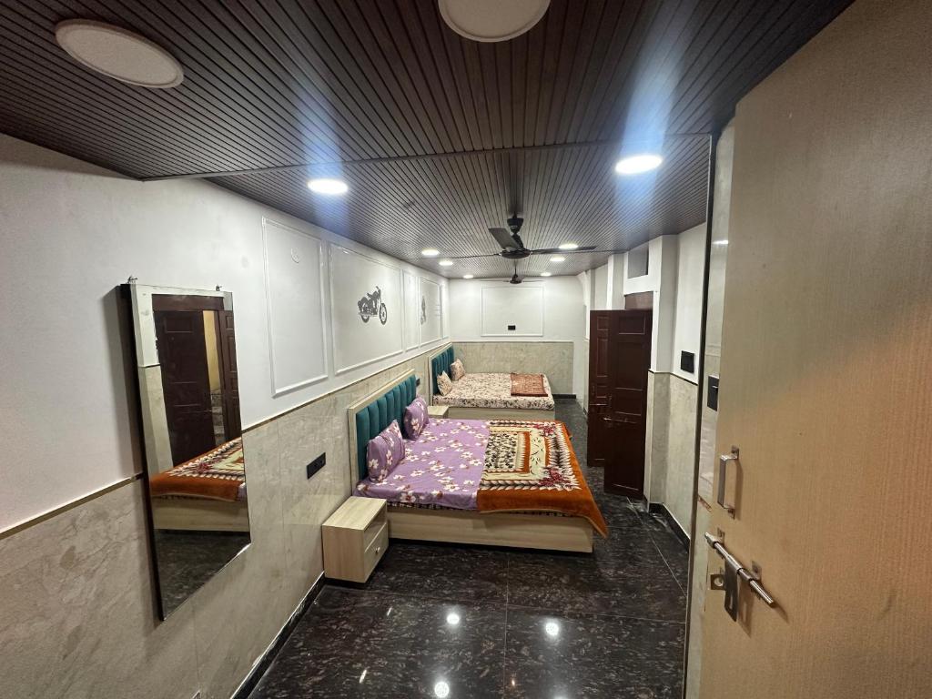 a hallway with two beds in a room at Hotel yes in Jaipur