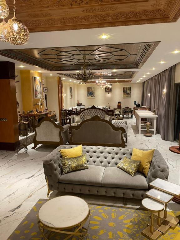 a large living room with a couch and tables at Dar Ghita in Arrouaïs