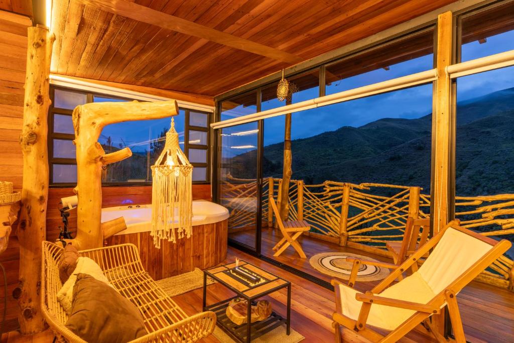 a log cabin with a view of the mountains at Mandrake Cabaña Nutria in Urrao