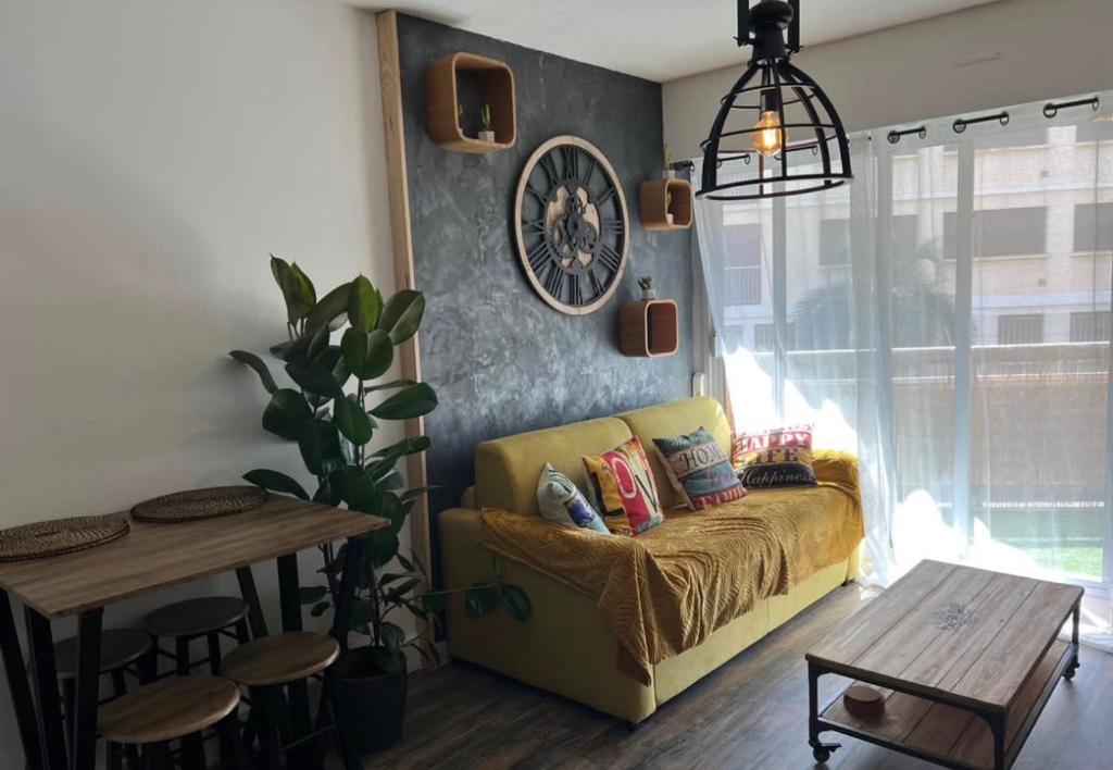a living room with a couch and a table at Vacances in Cavalaire-sur-Mer