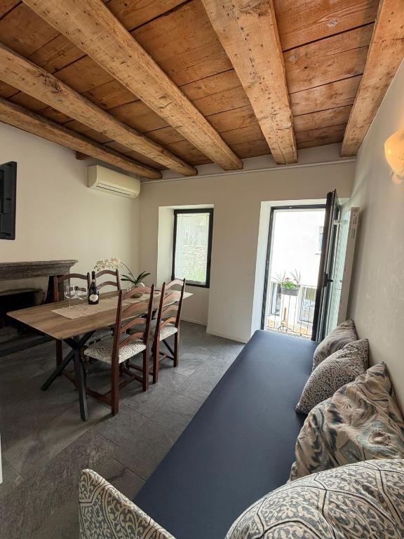 a living room with a table and a dining room at La Porta Segreta del Rustico in Gordola