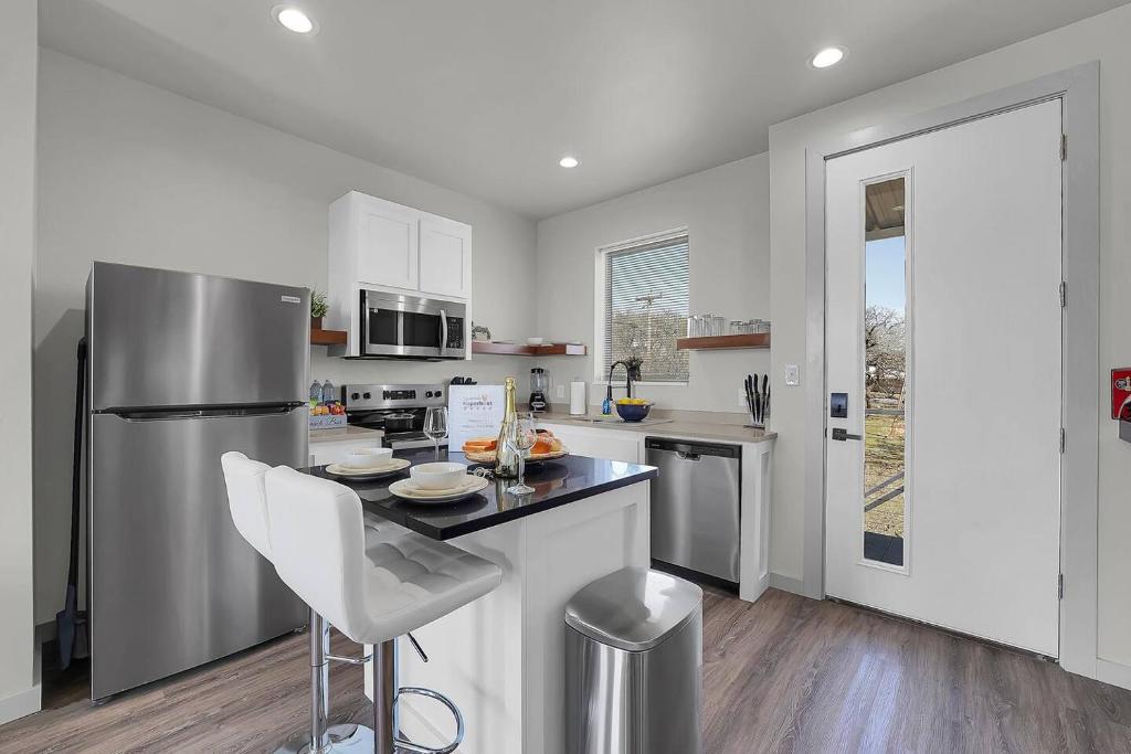 a kitchen with a stainless steel refrigerator and a counter at Medicine Park Flat's #03 in Medicine Park