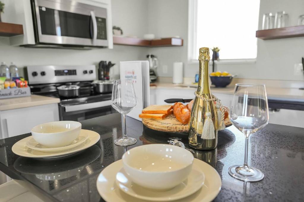 a kitchen counter with two plates and two wine glasses at Medicine Park Flat's #04 in Medicine Park