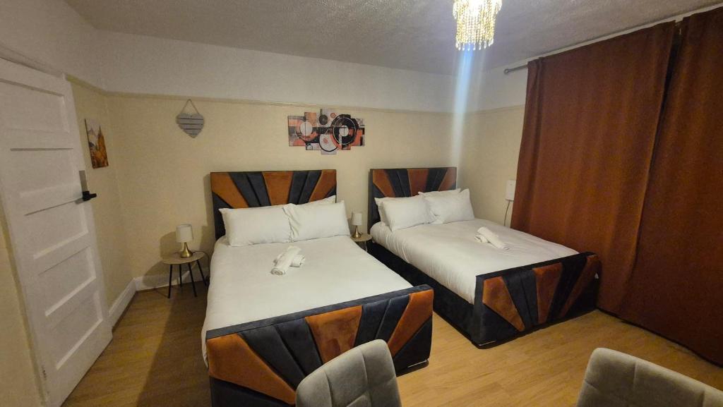 a hotel room with two beds in a room at The ultimate group stay in Catford