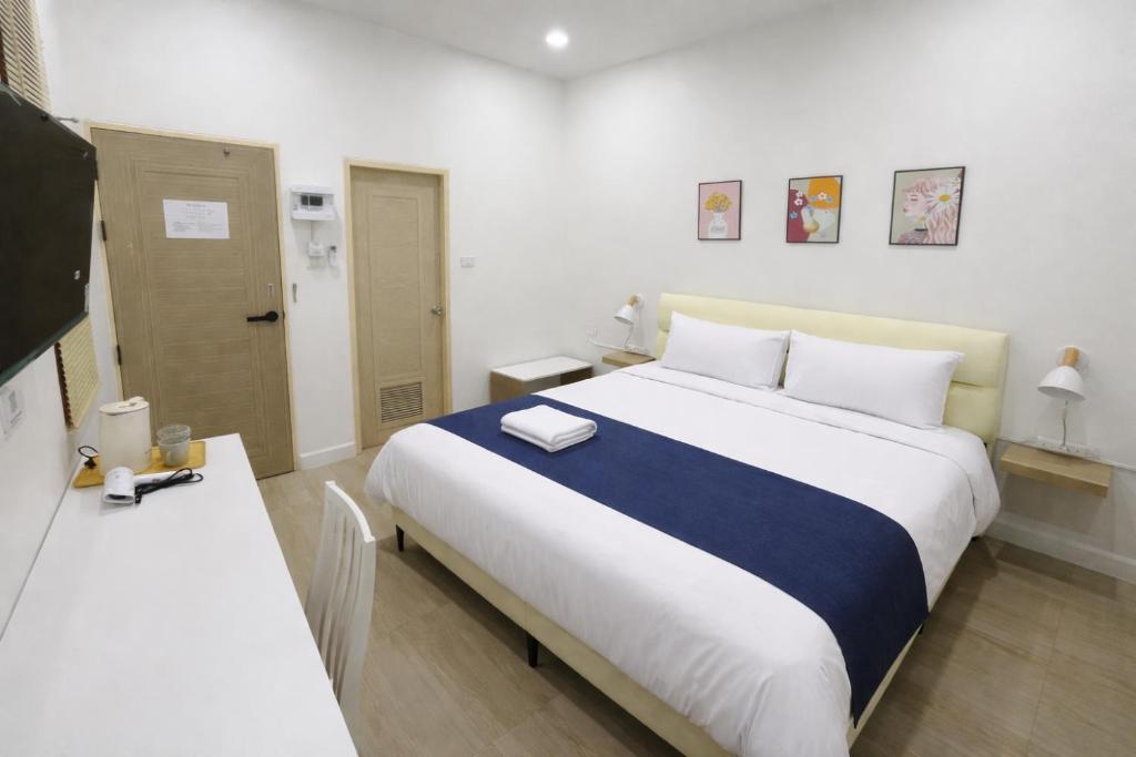 a hotel room with a large bed and a television at MinimalYala in Yala