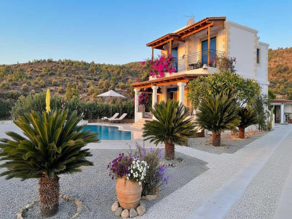 a villa with a swimming pool and a house at Rhodes Retreat with Private Pool in Kalathos
