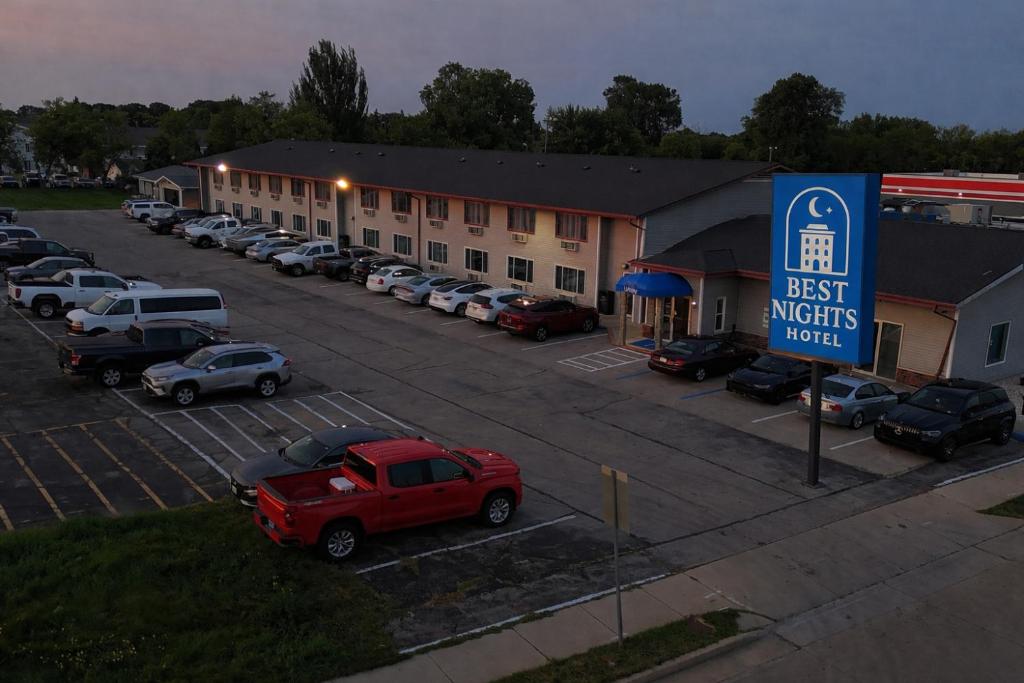 a best nights motel parking lot with cars parked at Best Nights Hotel in Fond du Lac