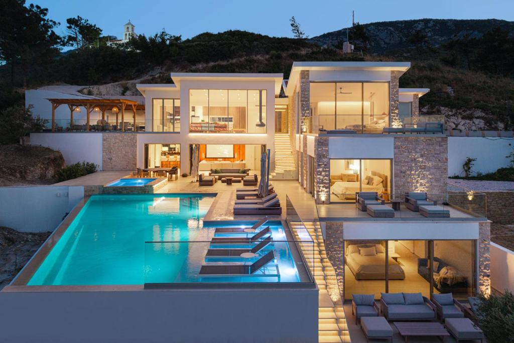 an image of a house with a swimming pool at Kokkari Villa in Kokkari