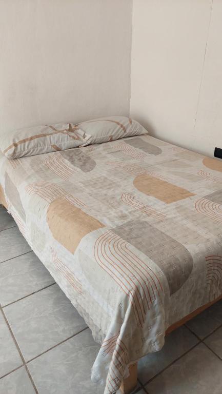 a bed sitting in a room with at Habitaciones el titis in Aguascalientes