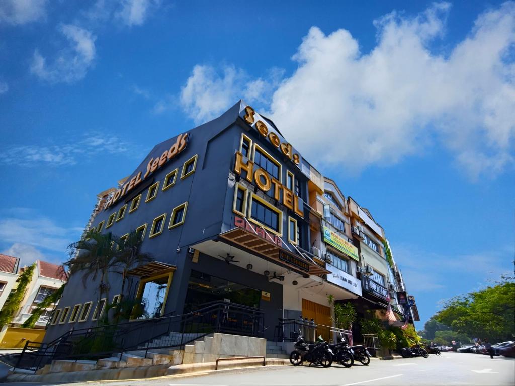 a blue building with motorcycles parked in front of it at Seeds Hotel Wangsa Maju in Kuala Lumpur