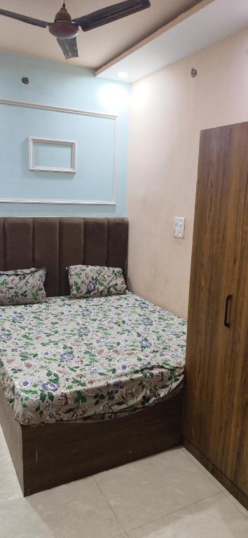 a bed with a wooden frame in a room at Madhav guest house in Agra
