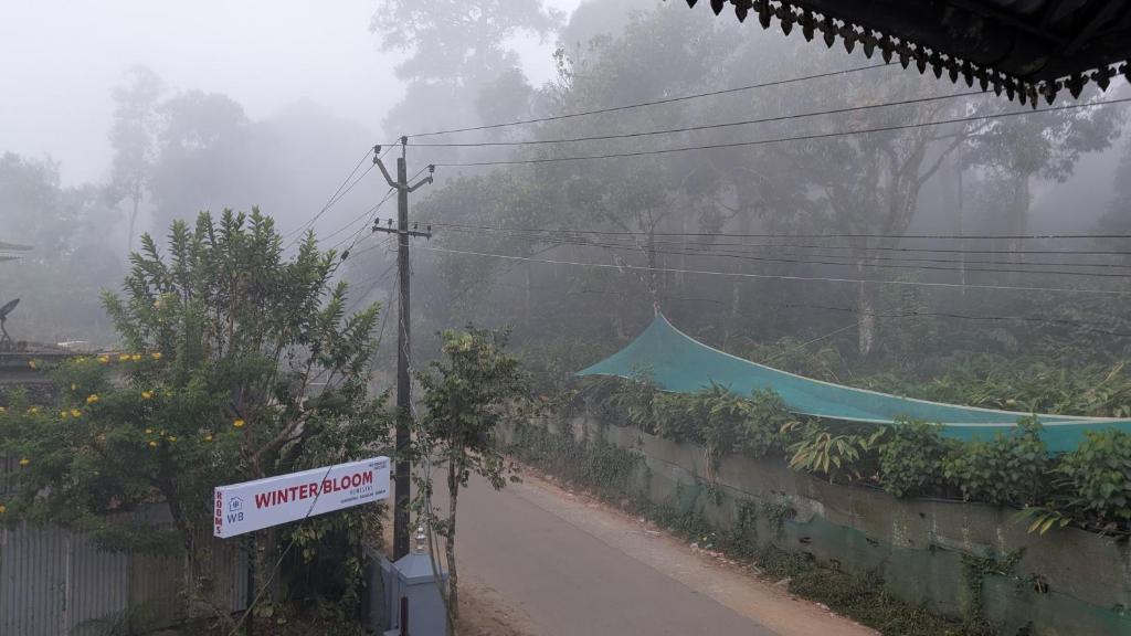 a street sign on the side of a road at Winter Bloom Homestay Munnar in Munnar
