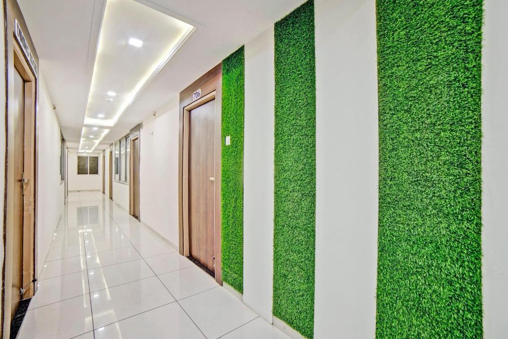 a corridor with green walls in a building at Townhouse Tulip in Vadodara