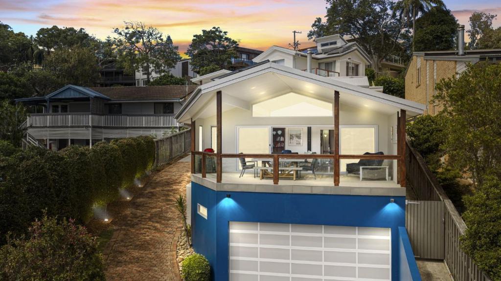 a house with a blue and white facade at For - Resters in Wamberal