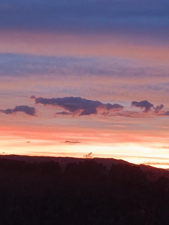 a view of a sunset from the top of a mountain at Samana wasi homestay in Ocosuyo
