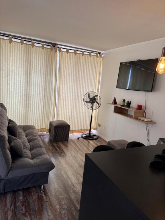a living room with a couch and a table at 2108 Depto a 15 minutos del Aeropuerto frente mall in Santiago