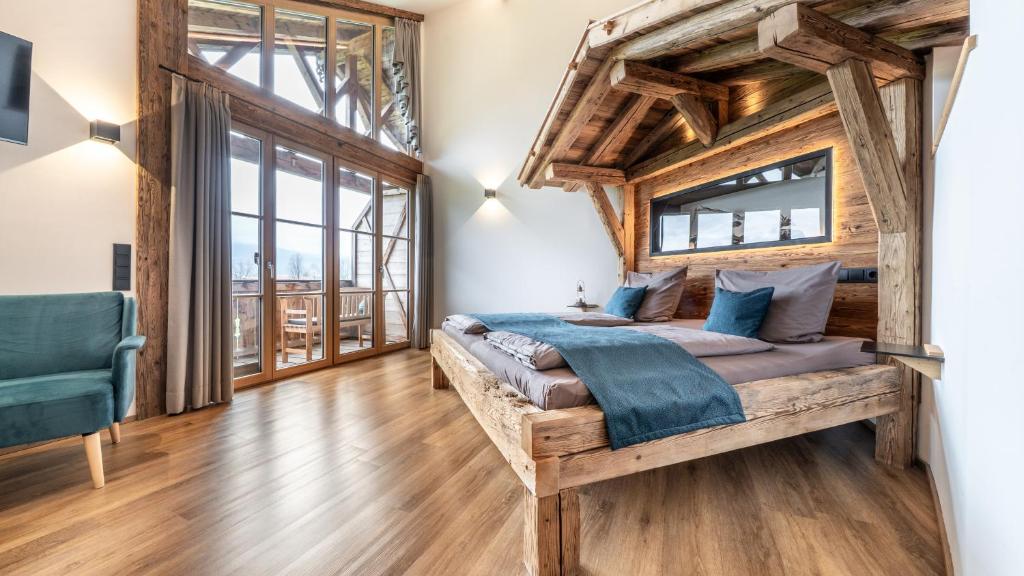 a bedroom with a bed with a wooden ceiling at Ferienwohnung Schmickhof in Gaißach