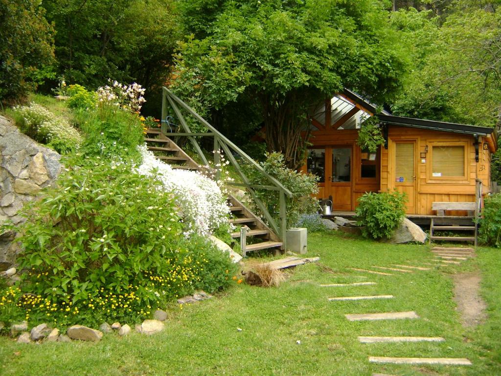 a wooden cabin with a staircase leading to it at El Recodo in San Martín de los Andes