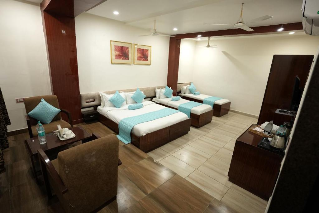 a living room with a bed and a couch at Staykart Lotus in Bhilwara