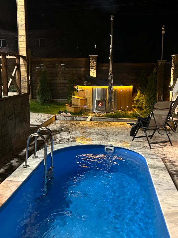 a large blue bath tub in a yard at night at Swiss House Dilijan in Dilijan